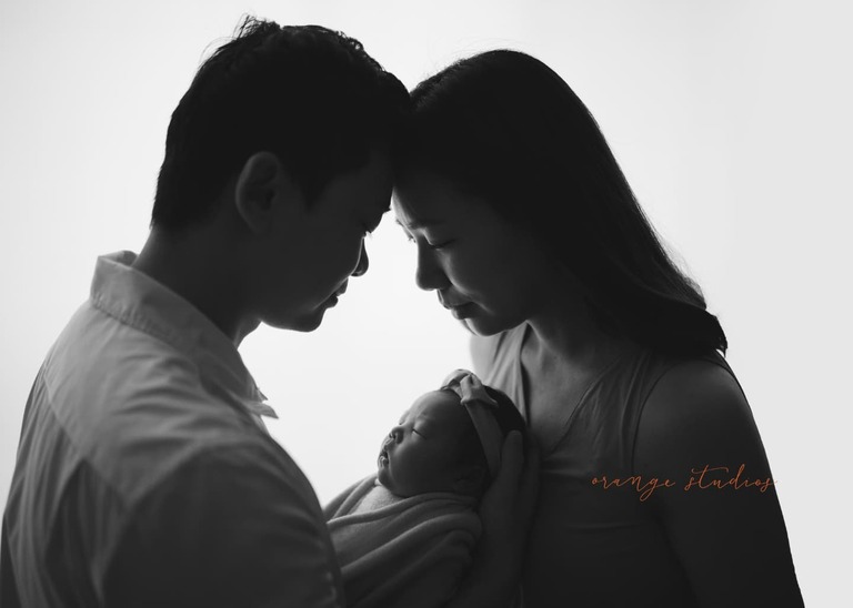 newborn photography with parents at orange studios.