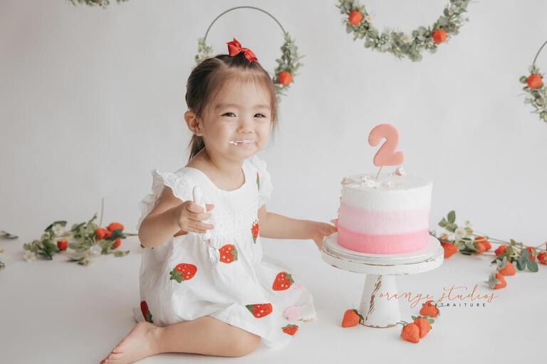 Baby enjoying a messy cake smash photoshoot in Singapore at Orange Studios.
