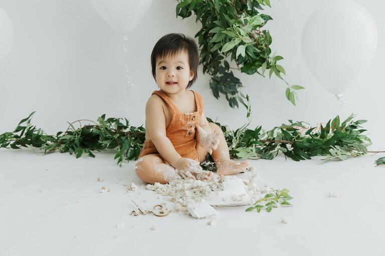 baby enjoying cake in orange studios