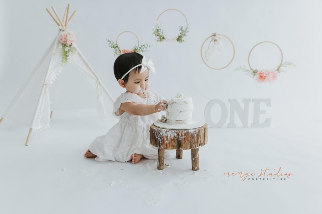 Baby smashing cake at Orange Studios Singapore – first birthday shoot