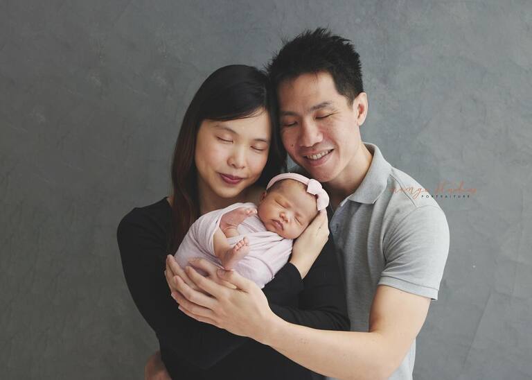 family posing with newborn at orange studios