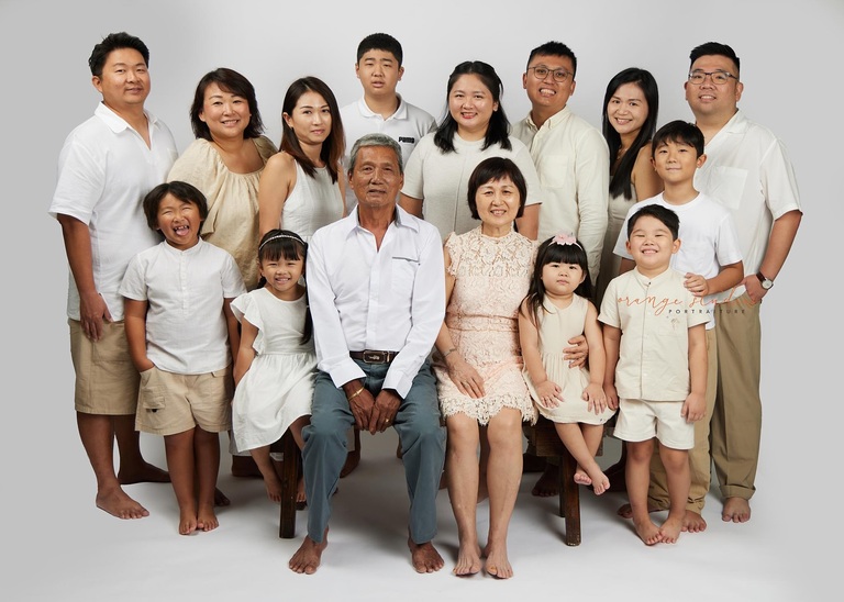 Three-generation family portrait in studio light studio