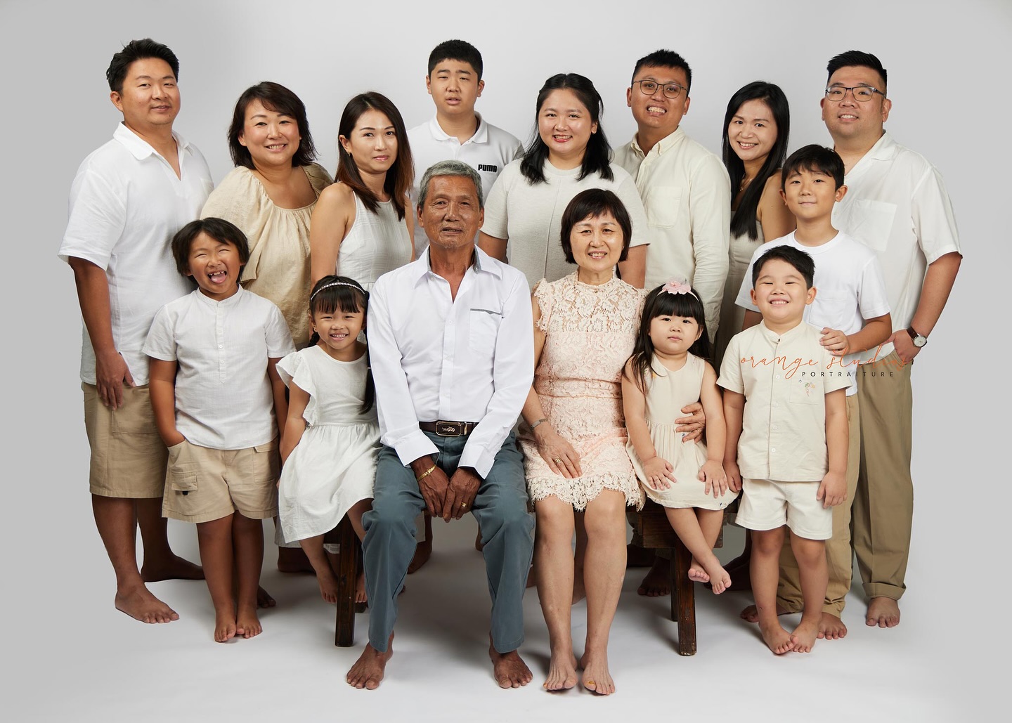 Three-generation family portrait in studio light studio