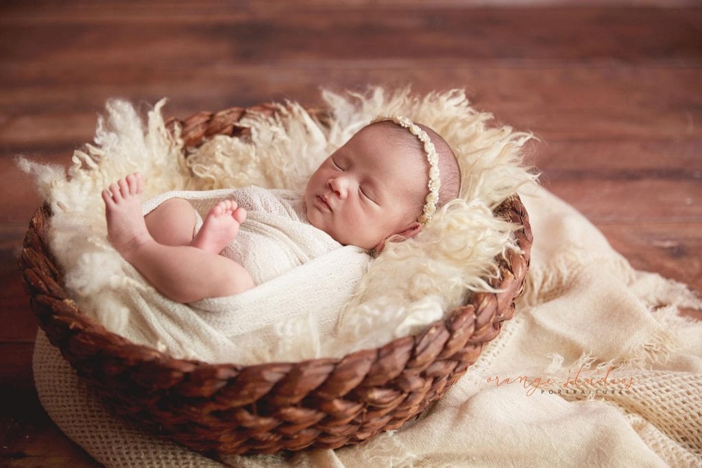 15 days old baby girl in basket newborn portraits in singapore studio