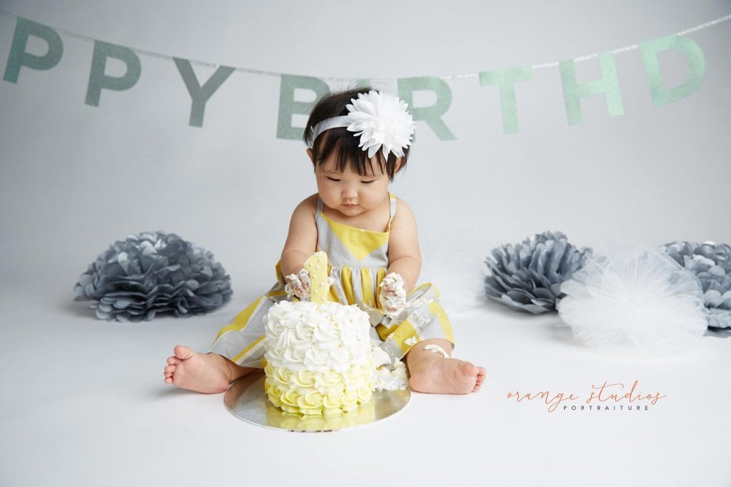 one year old baby girl cake smash portraits in singapore studio