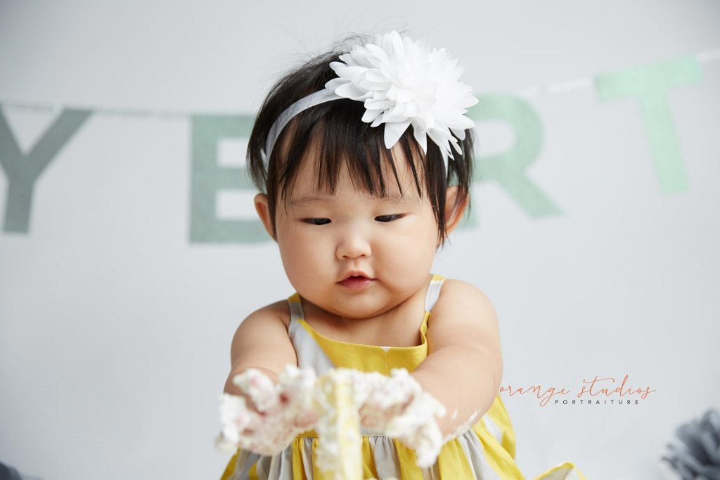one year old baby girl cake smash portraits in singapore studio