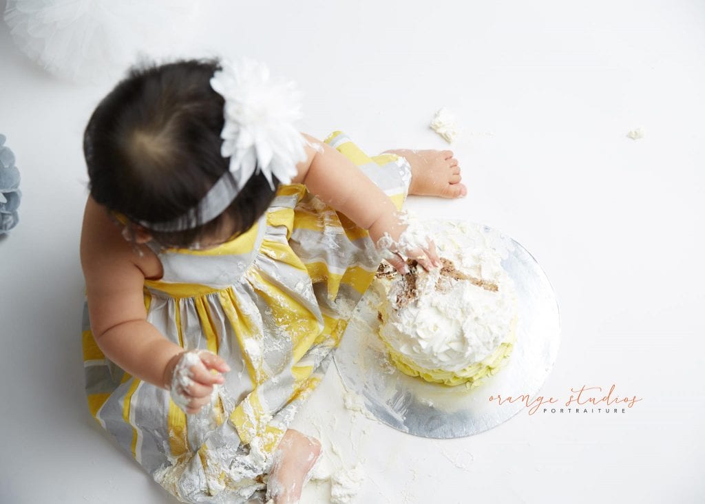 one year old baby girl cake smash portraits in singapore studio