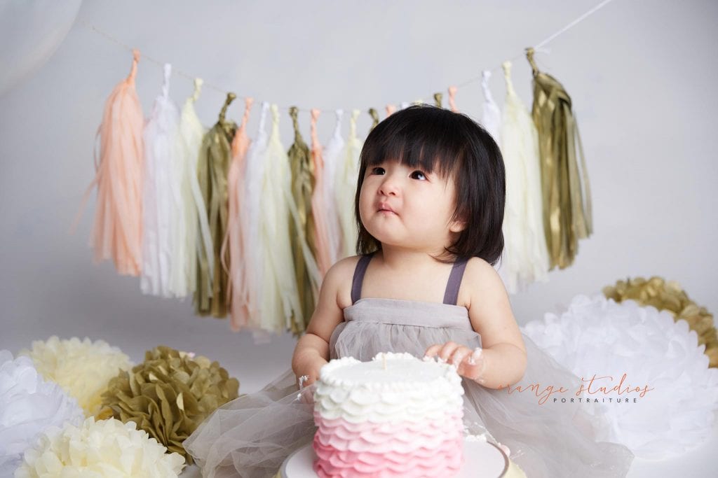 one year old baby girl cake smash portraits in singapore studio