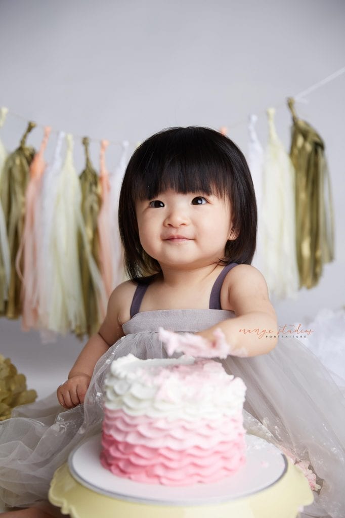 one year old baby girl cake smash portraits in singapore studio
