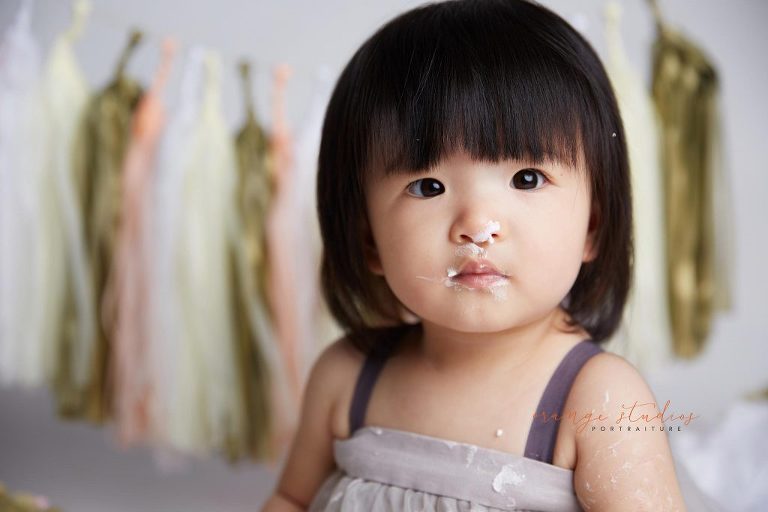 one year old baby girl cake smash portraits in singapore studio