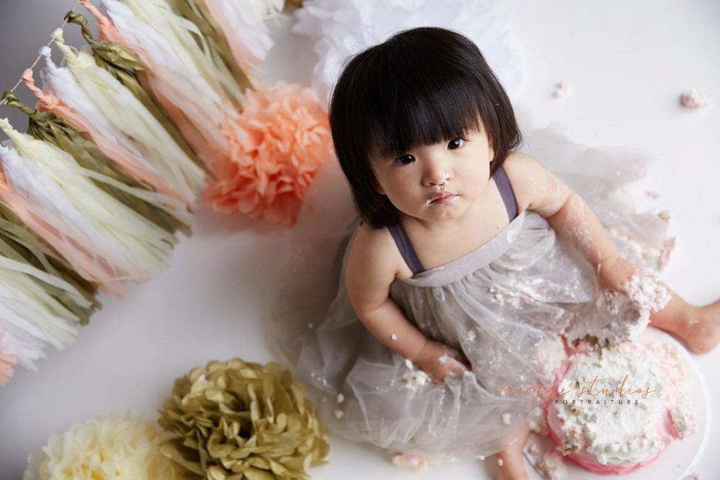 one year old baby girl cake smash portraits in singapore studio