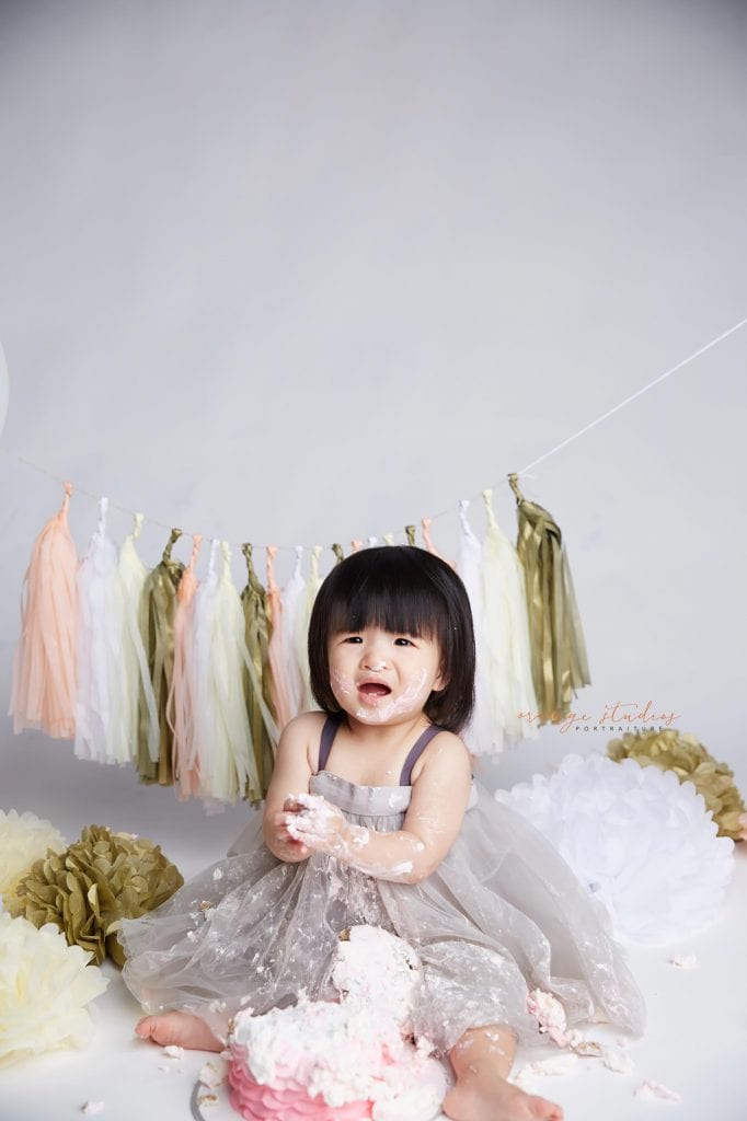 one year old baby girl cake smash portraits in singapore studio