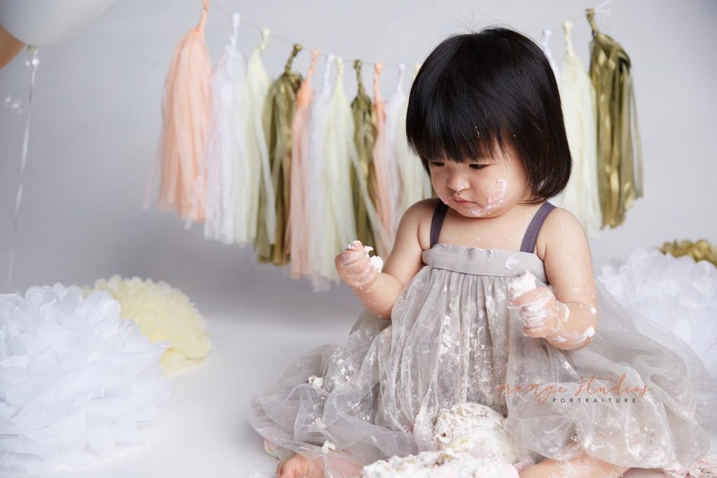 one year old baby girl cake smash portraits in singapore studio