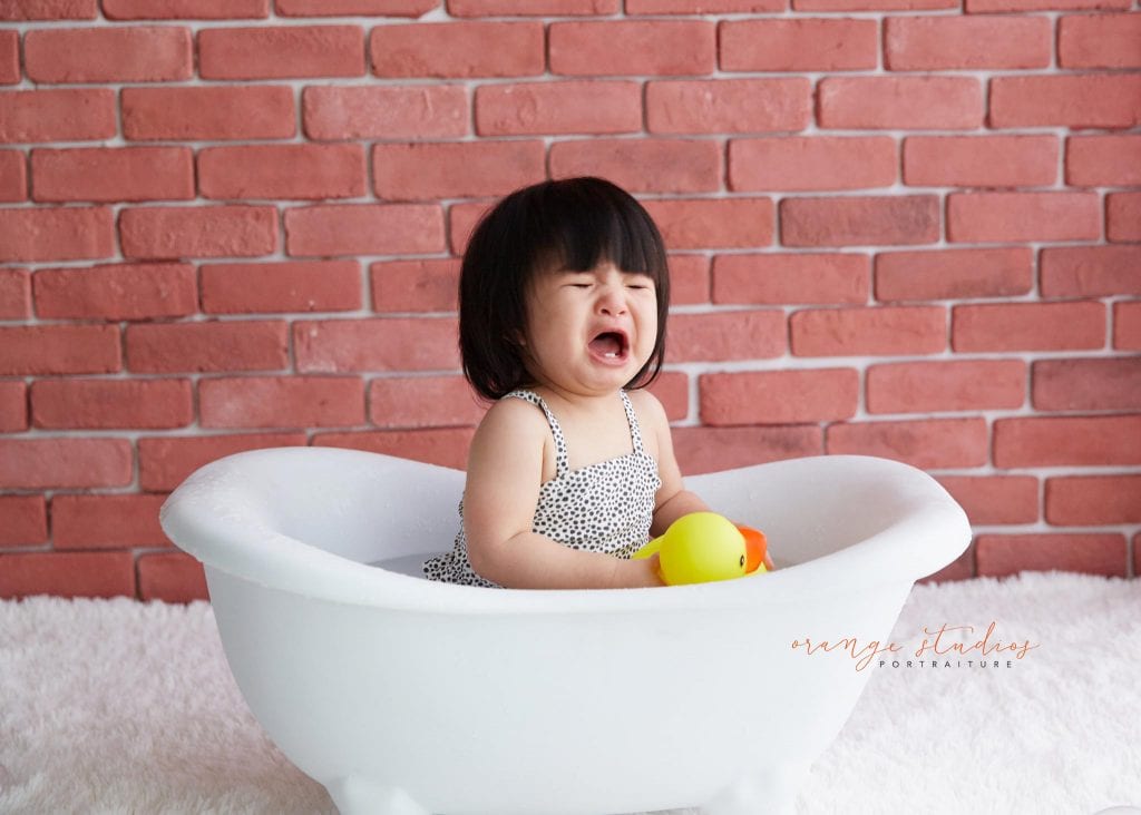 one year old baby girl cake smash bubble bath portraits in singapore studio