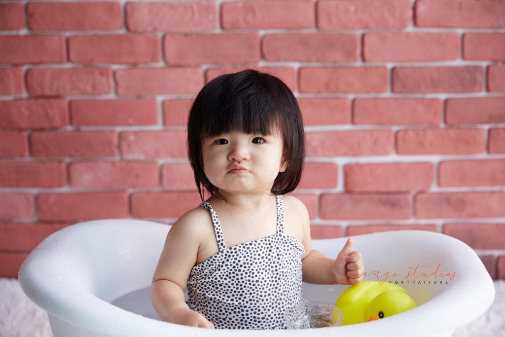 one year old baby girl cake smash bubble bath portraits in singapore studio