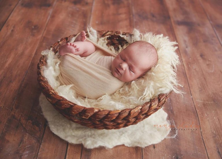 11 days old baby boy in basket newborn portraits in singapore studio
