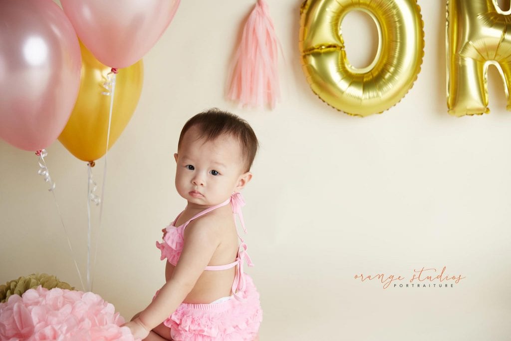 one year old baby girl cake smash portraits in singapore studio