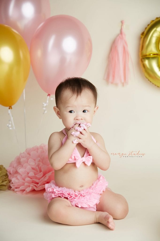 one year old baby girl cake smash portraits in singapore studio