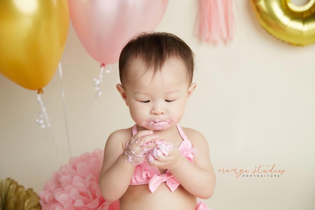 one year old baby girl cake smash portraits in singapore studio