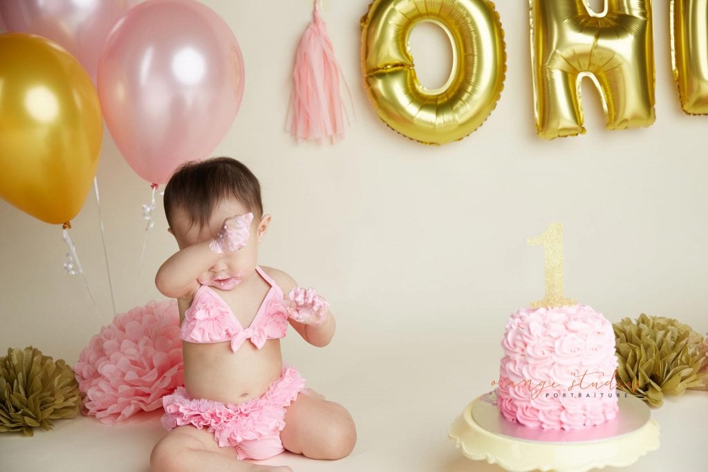 one year old baby girl cake smash portraits in singapore studio