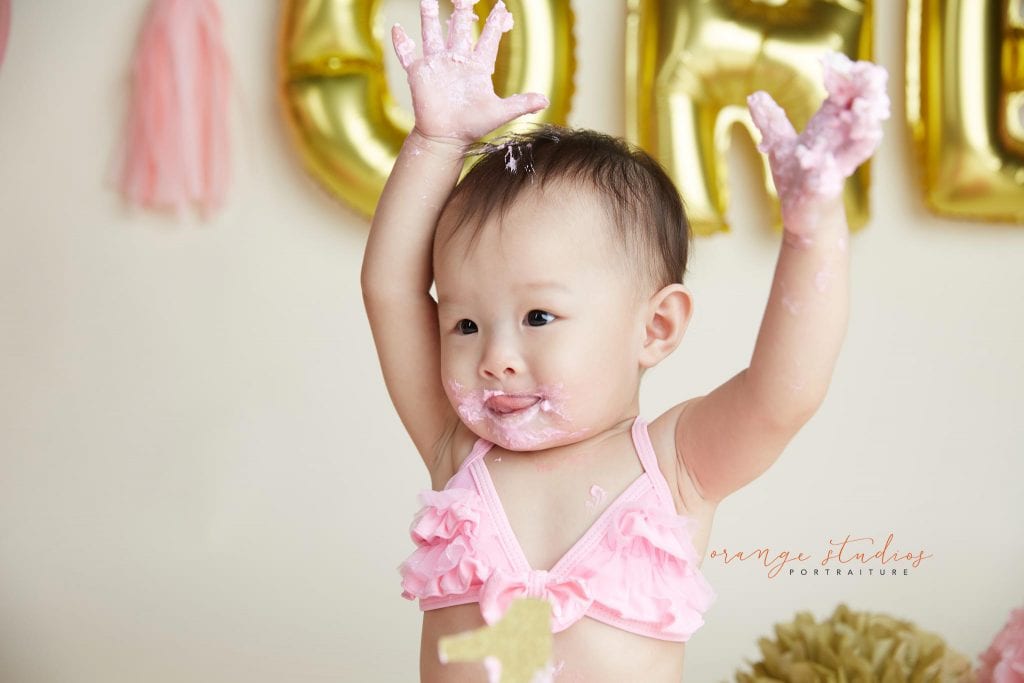 one year old baby girl cake smash portraits in singapore studio