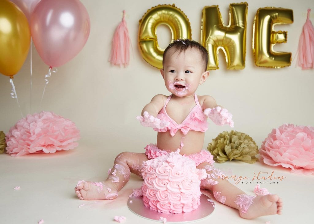 one year old baby girl cake smash portraits in singapore studio