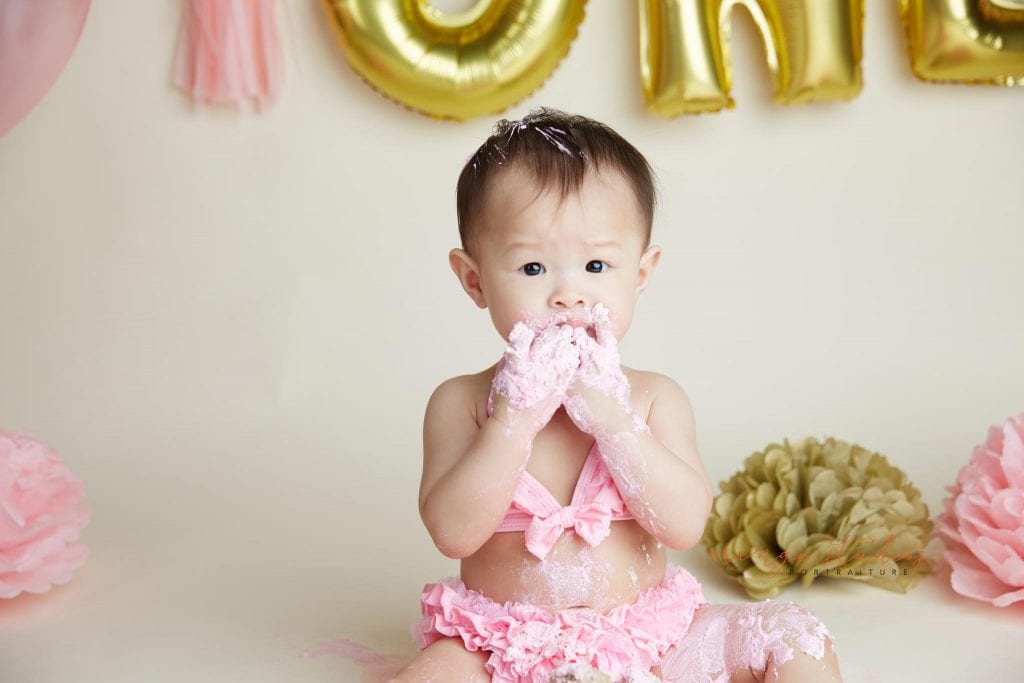 one year old baby girl cake smash portraits in singapore studio
