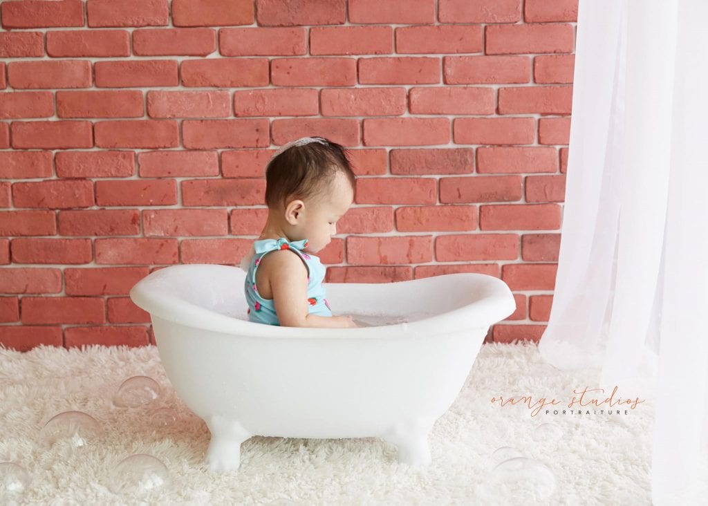 one year old baby girl cake smash bubble bath portraits in singapore studio