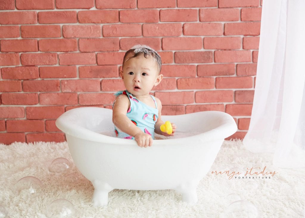 one year old baby girl cake smash bubble bath portraits in singapore studio