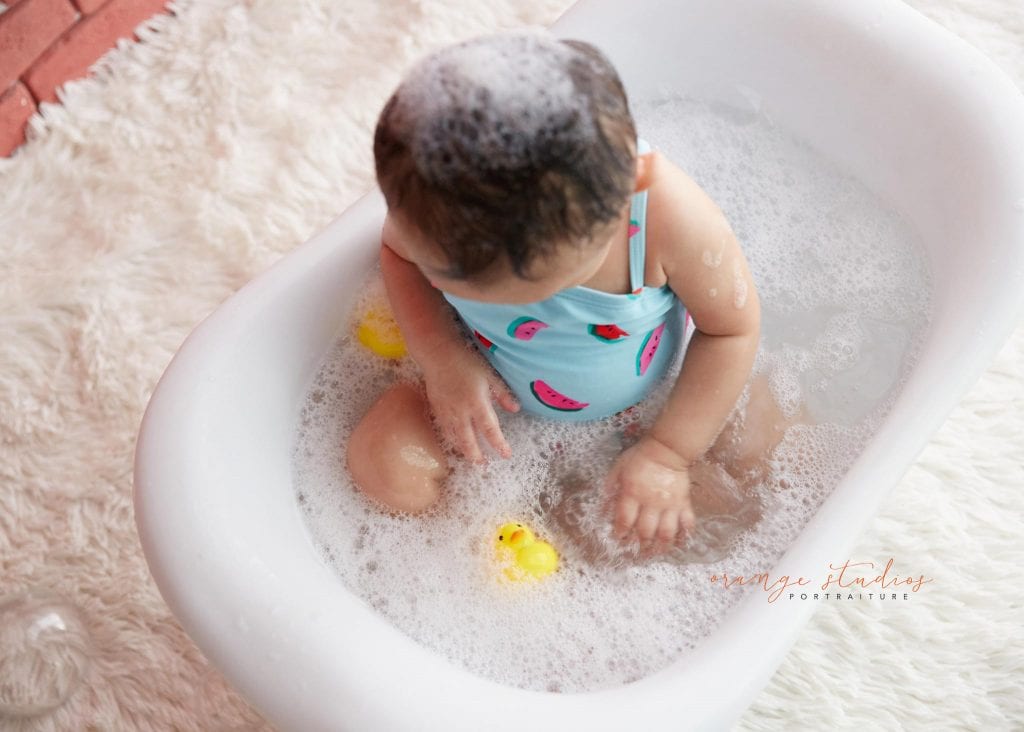 one year old baby girl cake smash bubble bath portraits in singapore studio