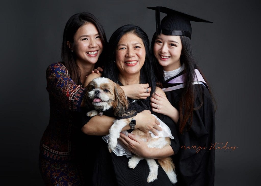natural and fun graduation family portraits with pet dog in singapore studio