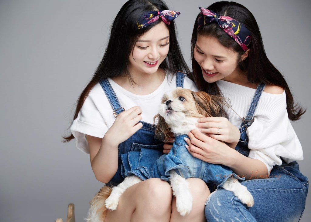 natural and fun sisters family portraits with pet dog in singapore studio