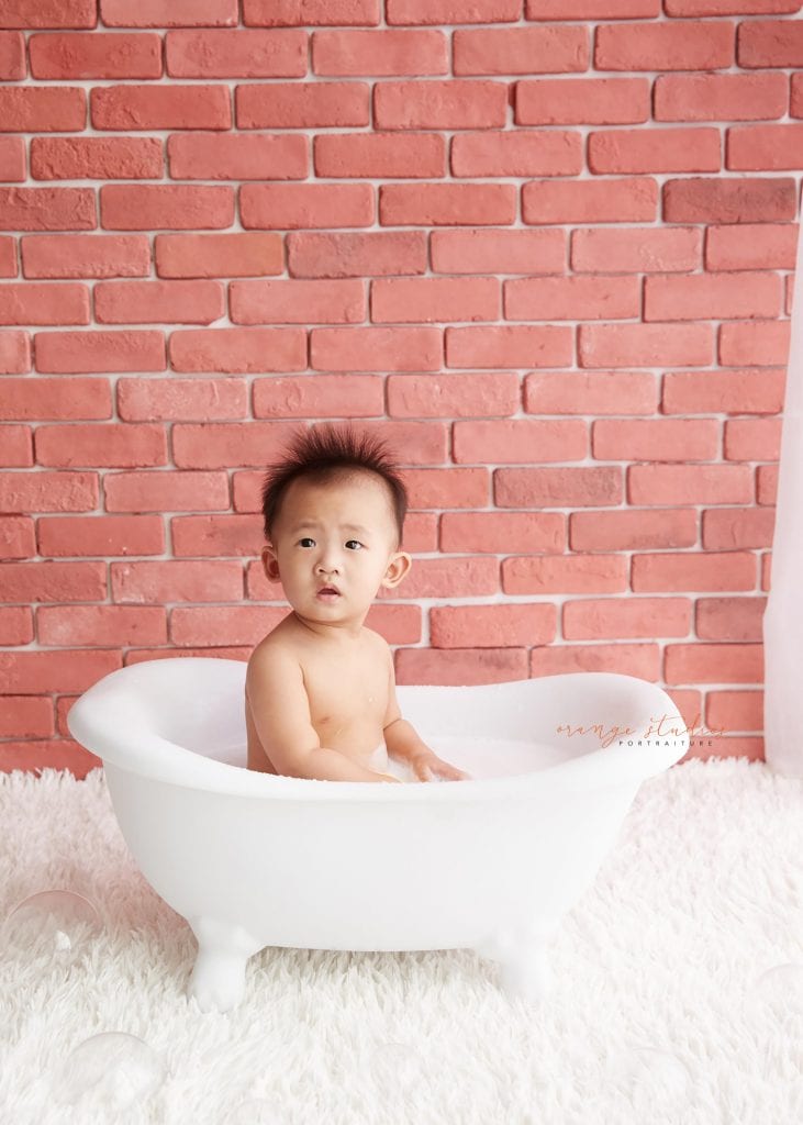 one year old baby boy cake smash and bubble bath portraits in singapore studio natural lighting