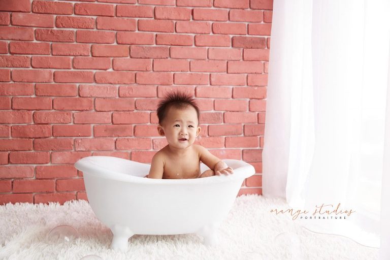 one year old baby boy cake smash and bubble bath portraits in singapore studio natural lighting