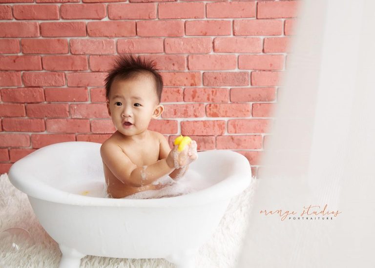 one year old baby boy cake smash and bubble bath portraits in singapore studio natural lighting