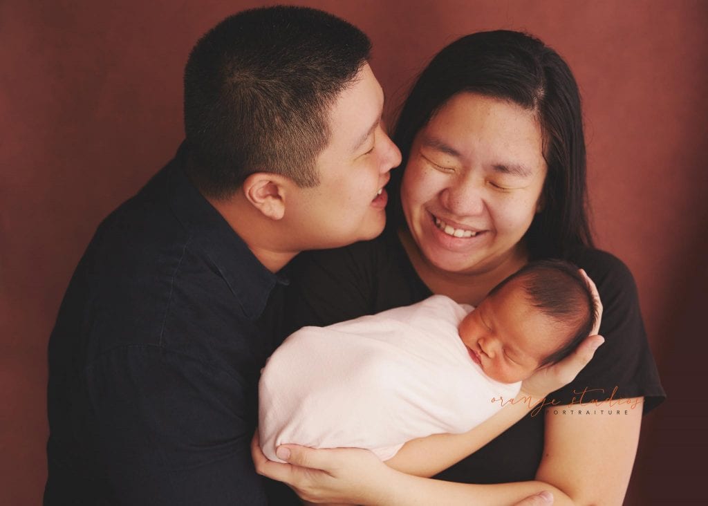 7 days old baby girl newborn portraits with parents in singapore studio