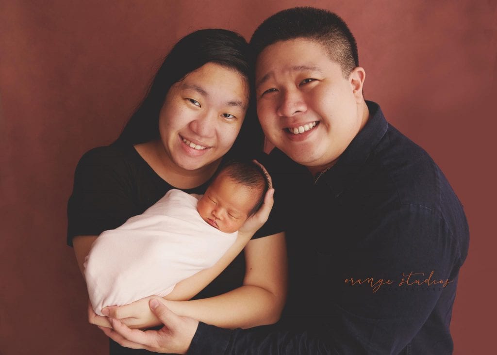 7 days old baby girl newborn portraits with parents in singapore studio