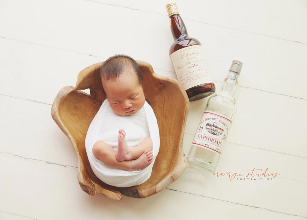7 days old baby girl newborn portraits in prop with dad's wine in singapore studio