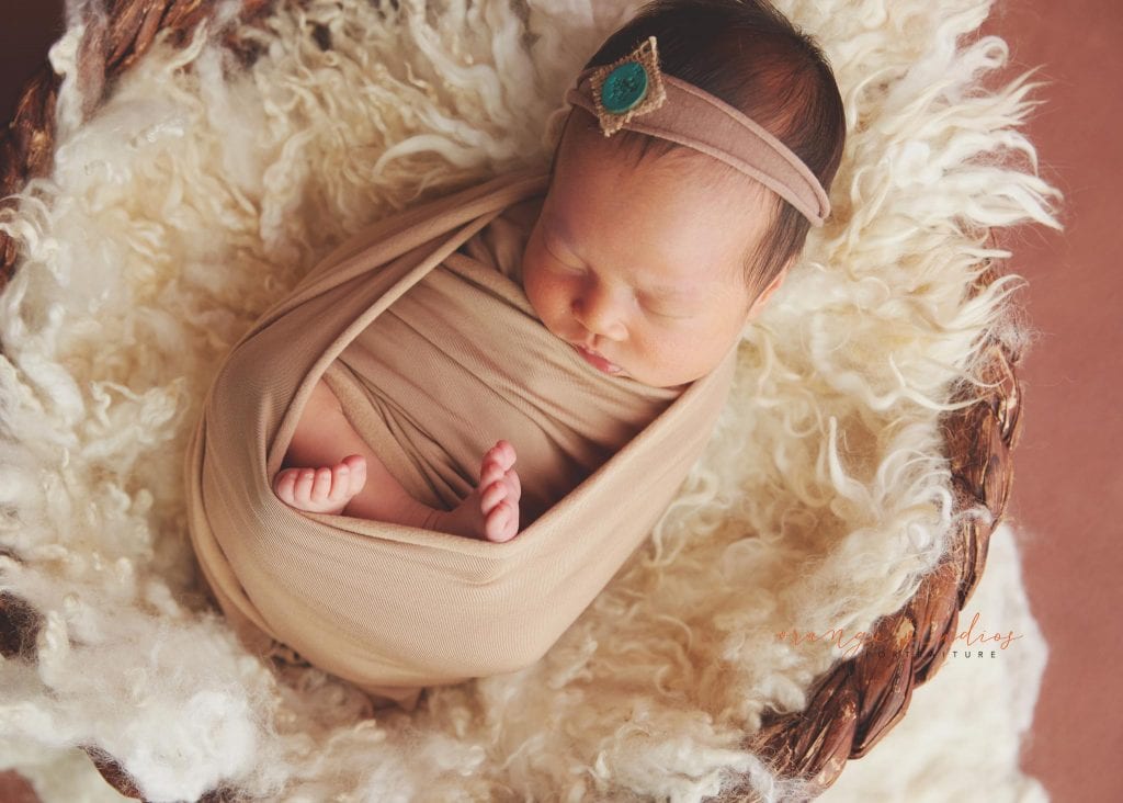 7 days old baby girl newborn portraits in rattan basket in singapore studio