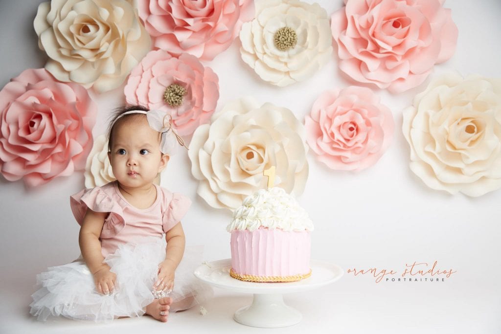 one year old baby girl flower wall cake smash portraits in singapore studio