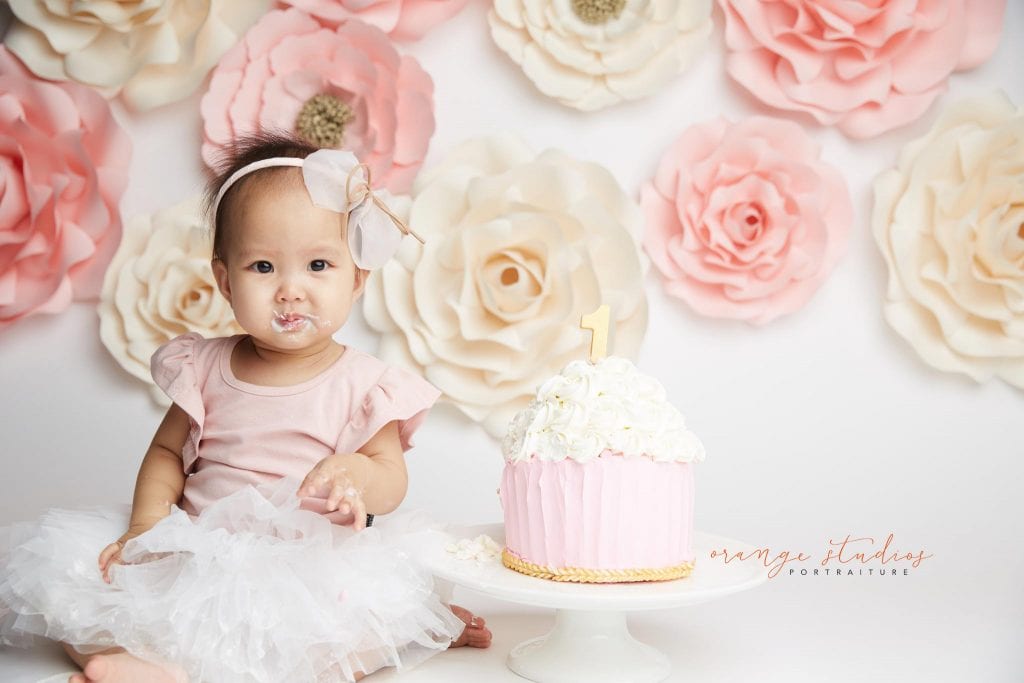 one year old baby girl flower wall cake smash portraits in singapore studio