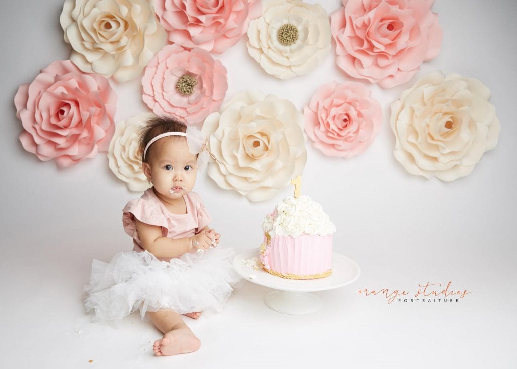 one year old baby girl flower wall cake smash portraits in singapore studio