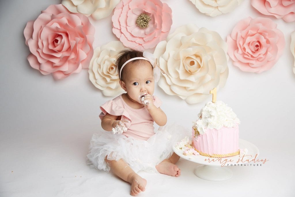 one year old baby girl flower wall cake smash portraits in singapore studio