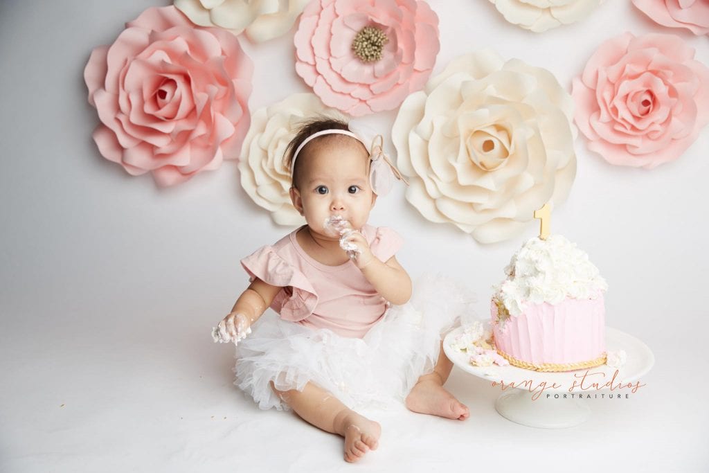 one year old baby girl flower wall cake smash portraits in singapore studio