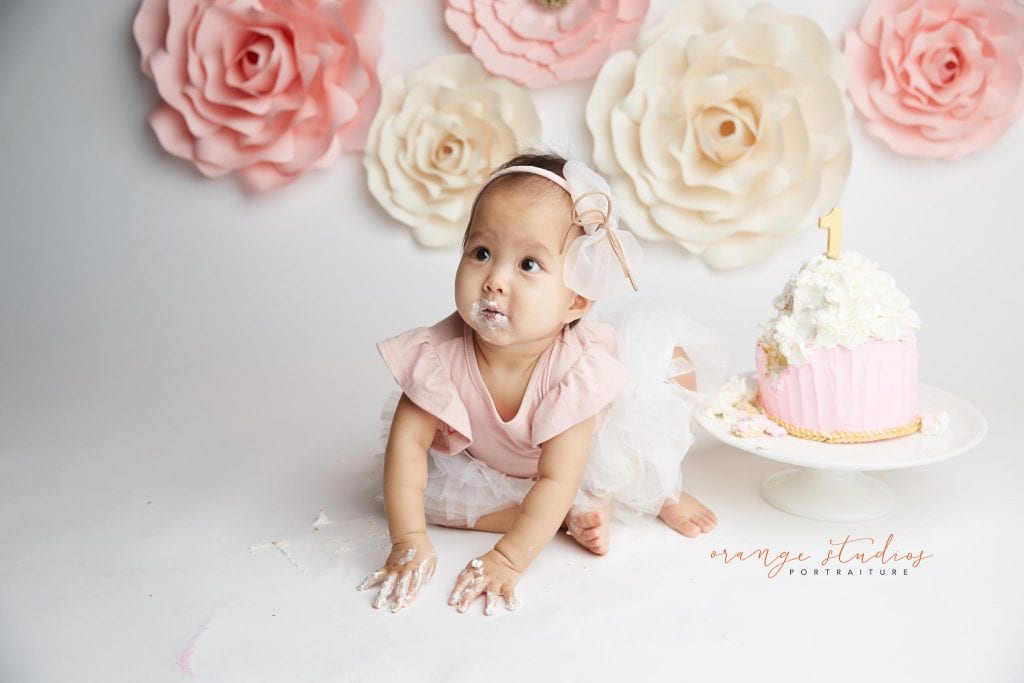 one year old baby girl flower wall cake smash portraits in singapore studio