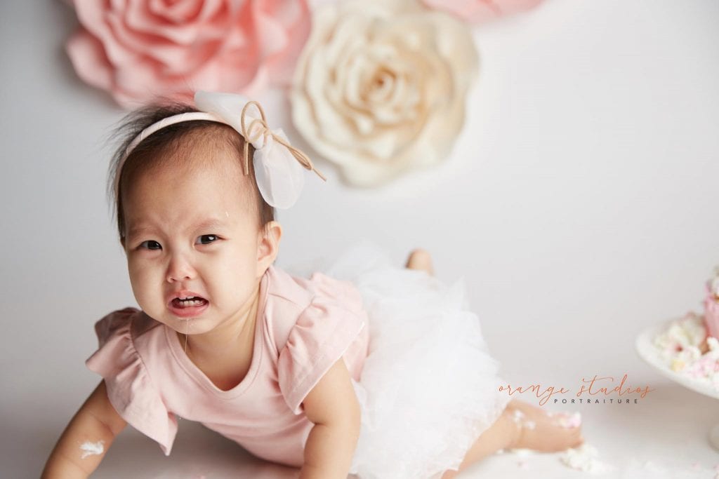 one year old baby girl flower wall cake smash portraits in singapore studio