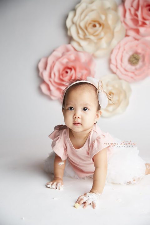 one year old baby girl flower wall cake smash portraits in singapore studio