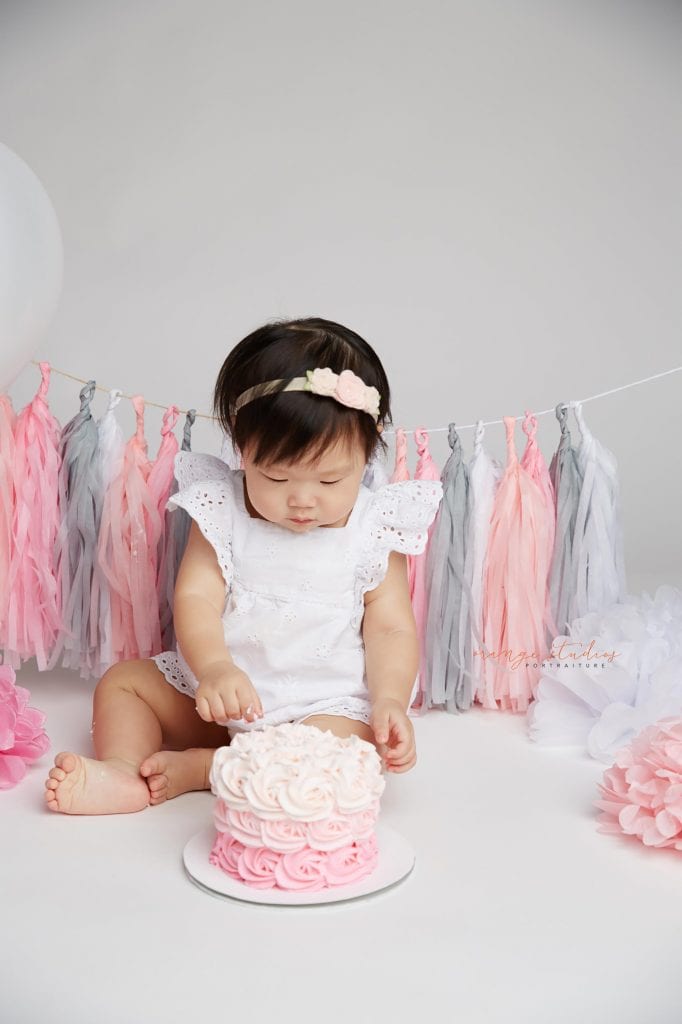 one year old baby girl cake smash portraits in singapore studio