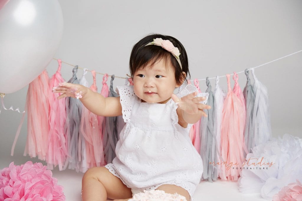 one year old baby girl cake smash portraits in singapore studio