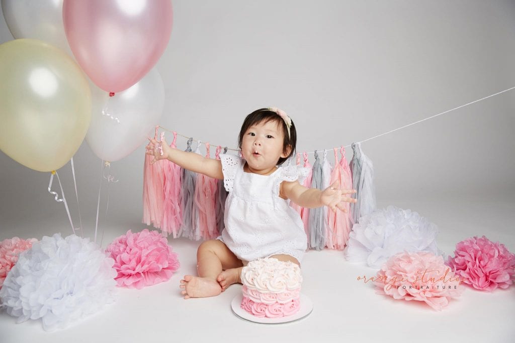 one year old baby girl cake smash portraits in singapore studio